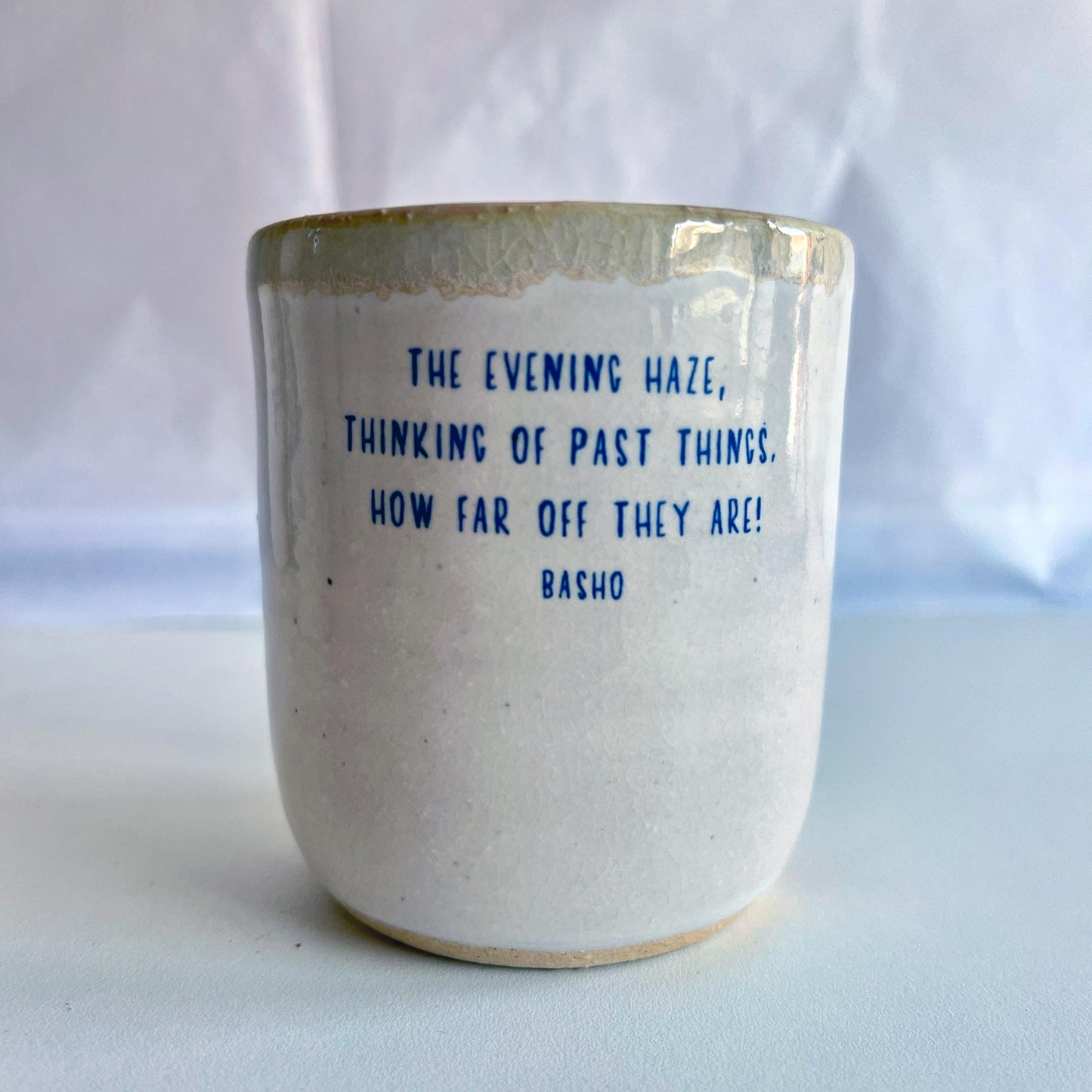 Ceramic mug with text on a white background