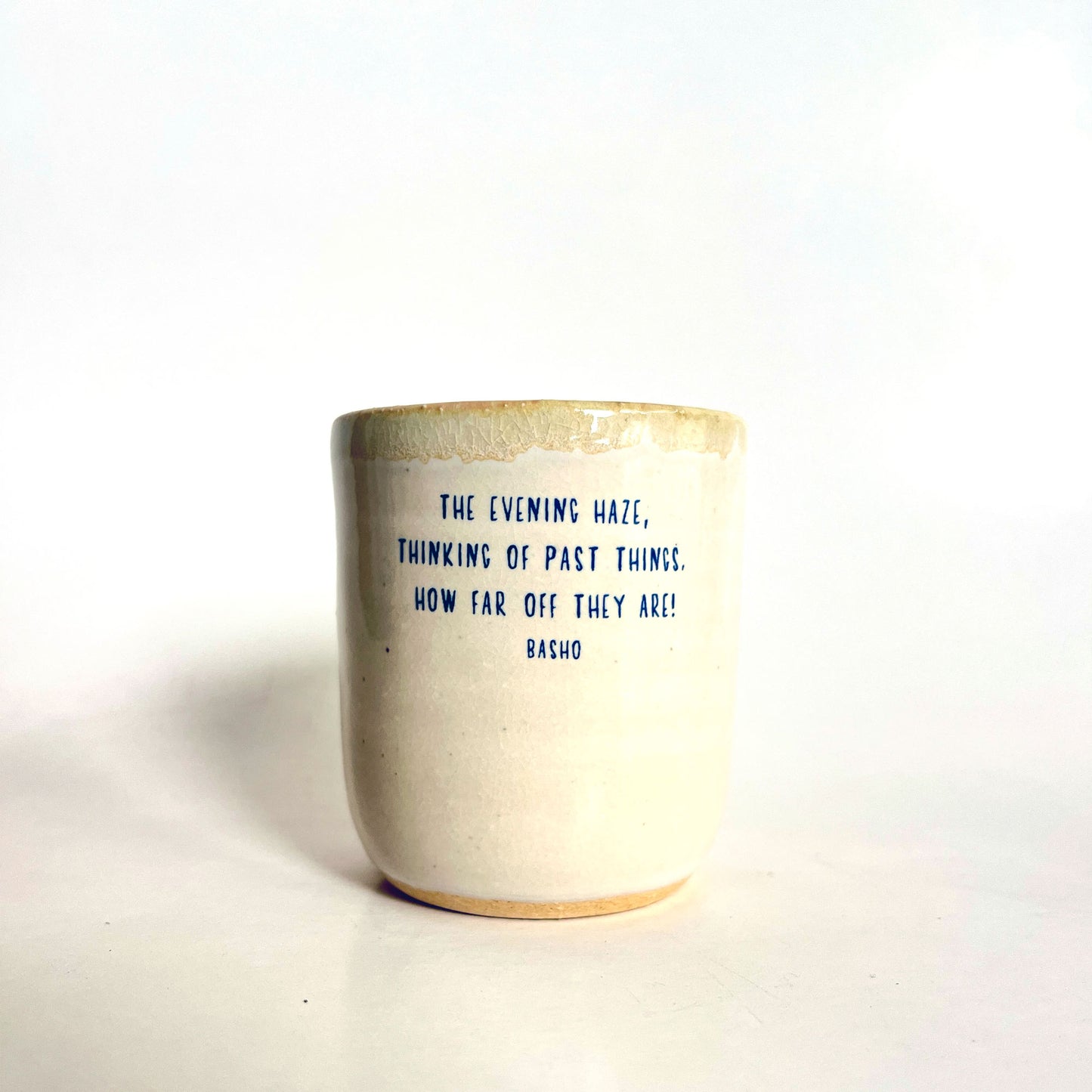 Ceramic mug with a blue text quote on a white background