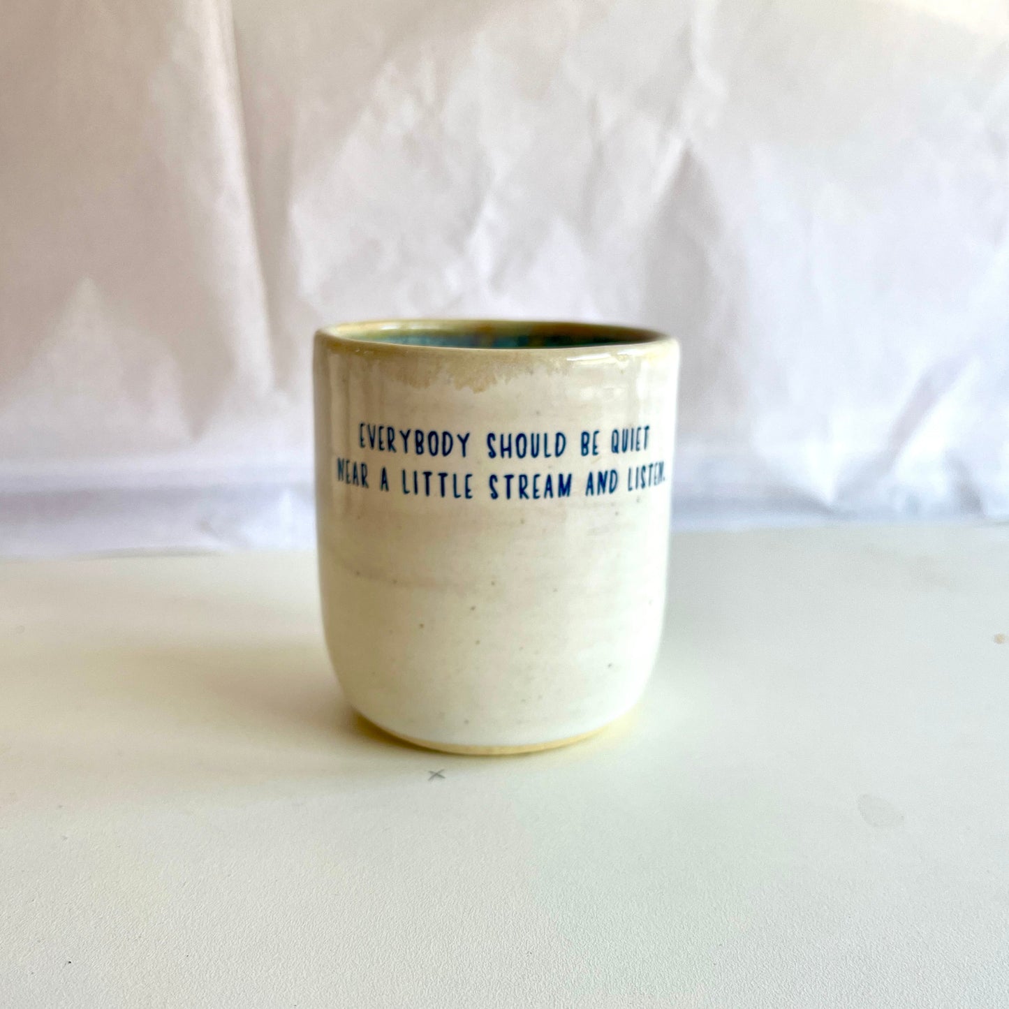 Ceramic cup with text on a white background