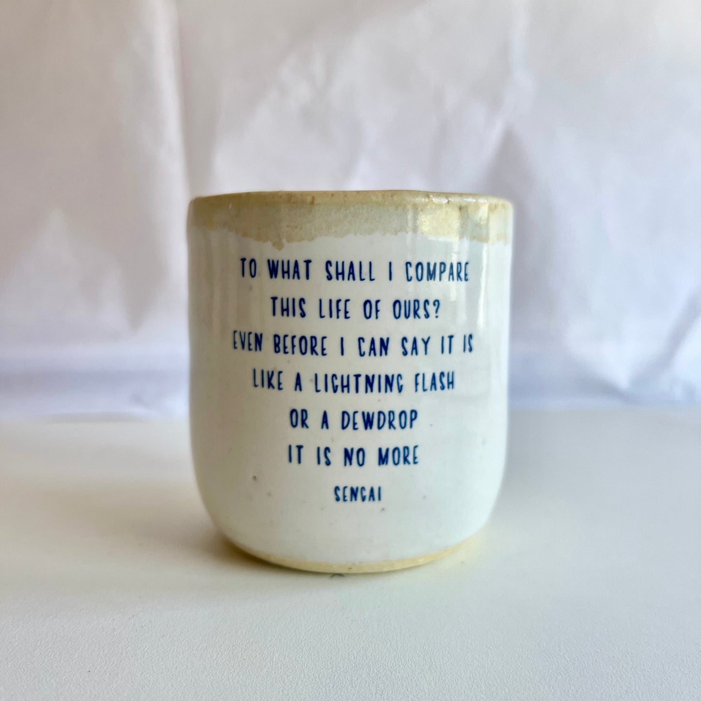 Ceramic cup with text on a white background