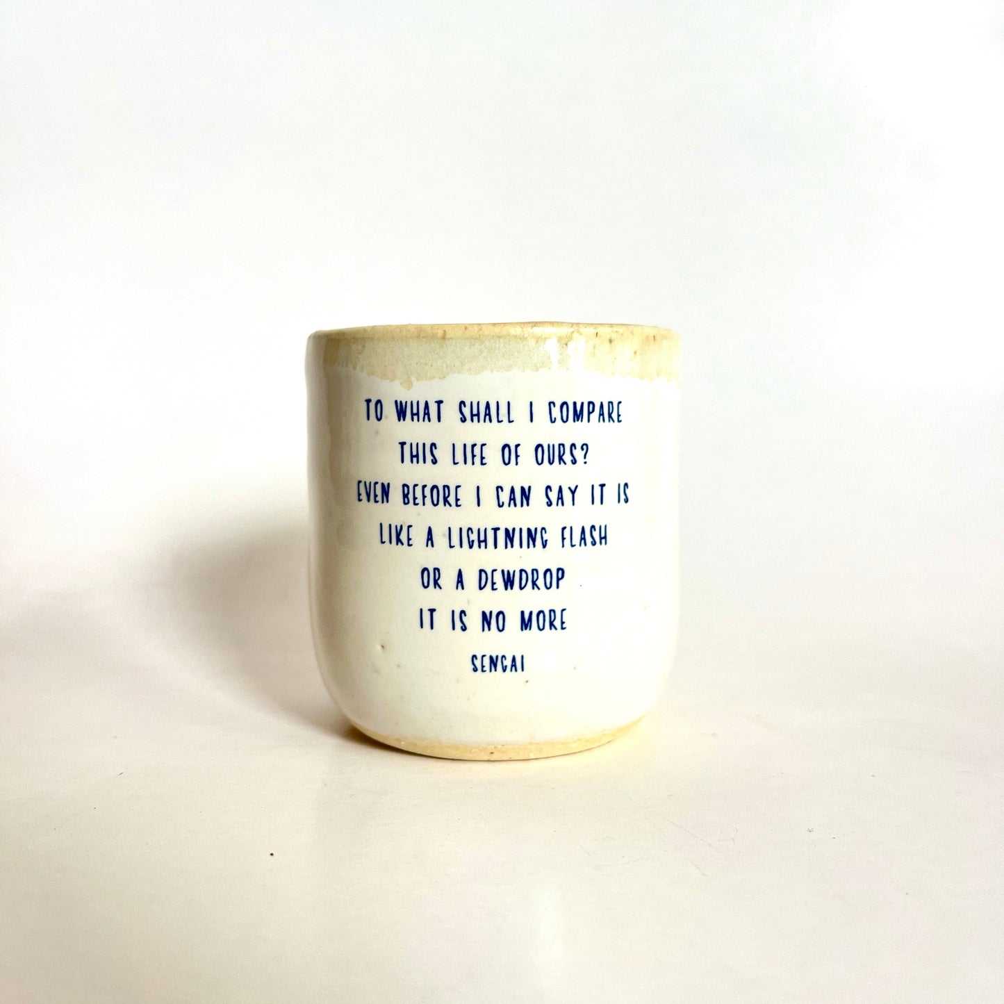 Ceramic mug with text on a white background