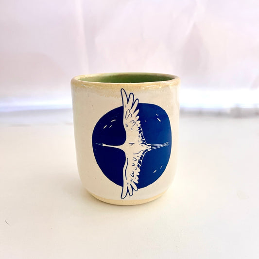 Ceramic mug with a blue bird design on a white background