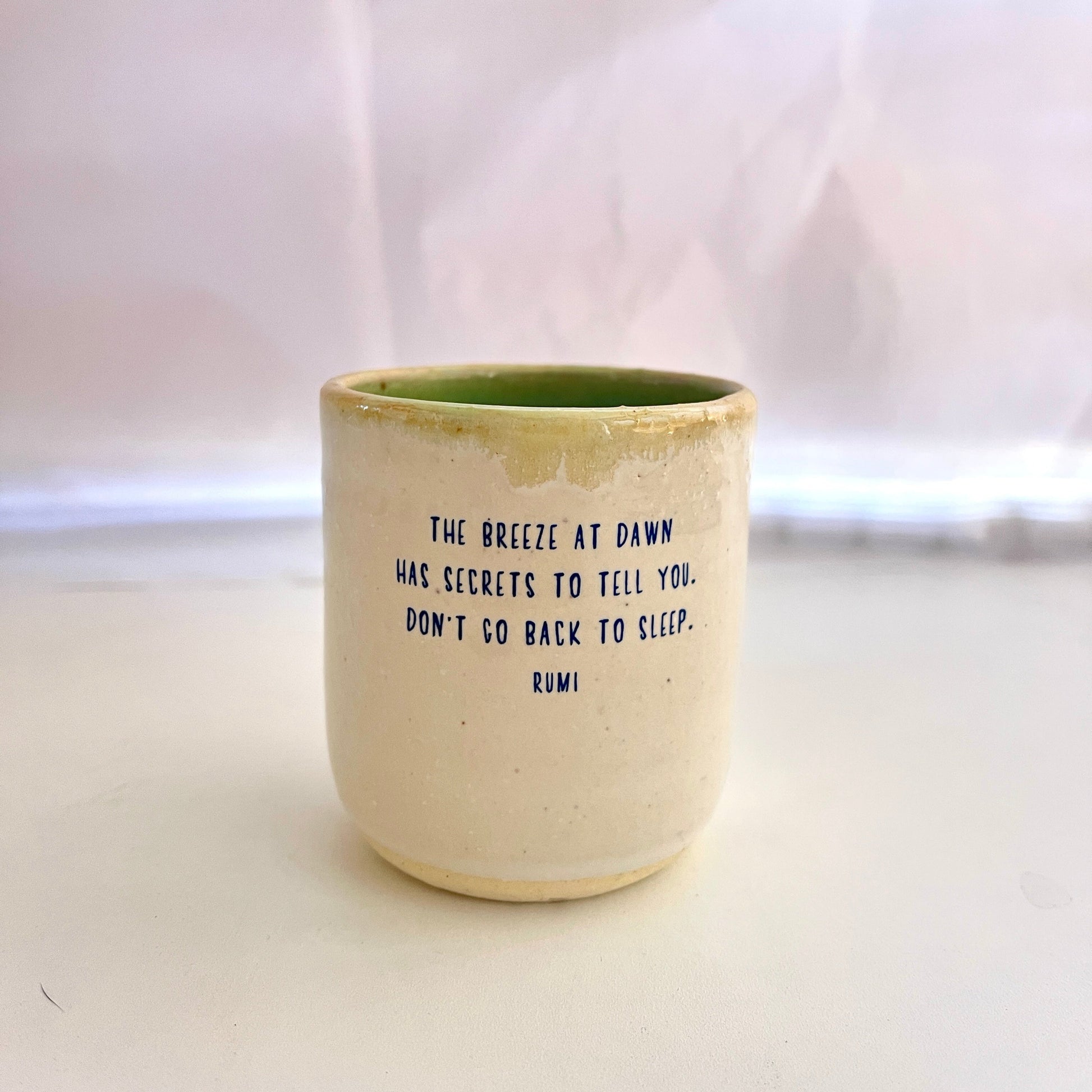Ceramic cup with text on a white background
